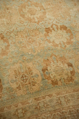Textured low pile of a distressed vintage Afshar rug in coffee brown and sea foam green.