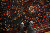 Looking down at the vintage Bakhtiari carpet, showing its rich texture and central medallion design.