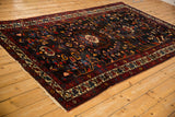 Angled perspective on a vintage Bakhtiari rug showing its staggered medallion and rich gem-toned design.
