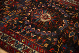 Staggered center medallion with gem-toned ruby and sapphire details on a vintage Bakhtiari carpet.