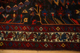 Persian Bakhtiari carpet border showing gem-toned tree of life motifs and low hand-knotted pile.