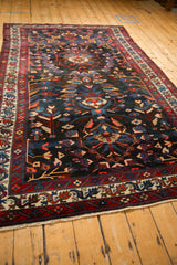 Lengthwise perspective of a vintage Persian Bakhtiari carpet highlighting its complex pattern and rich colors.