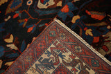 Folded corner of a Bakhtiari carpet revealing the hand-knotted weave and intact side cord selvage.