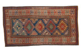 Antique Kazak rug with aquatic blue field, diamond hook medallions, and floral pawn borders.