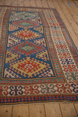 Antique Kazak rug border: reciprocating pawn and floral patterns in sapphire, madder, gold.