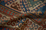 Storied antique Kazak rug detail: sapphire blue geometric medallions and pawn motif.