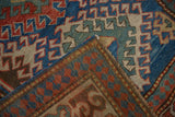 Collector antique Kazak rug corner, showing geometric blue, red, teal pile and woven foundation.