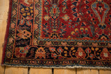 Detailed view of a vintage Sarouk rug's floral border and threadbare selvage.