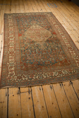 Distressed antique Bijar rug corner, worn pile, with ivory, burgundy, and dusty teal border.