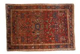Antique Farahan Sarouk rug with an allover floral design in rich ruby red and sapphire blue tones.