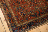 Boteh corner spandrel and meandering vine border on an antique Farahan Sarouk rug.