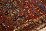 Storied texture and deep gem-tones in the floral field of an antique Persian rug.