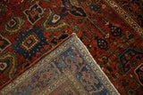 The folded corner of an antique Farahan Sarouk rug, showing the hand-knotted back and selvage.