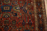 Close view of the meandering vine border and gem-toned floral field of a Persian rug.