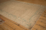 Antique Peking rug showcasing its curvilinear seafoam green tendril border and beige field.