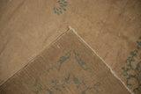 Hand-knotted construction of a beige antique Peking rug with green floral motif.
