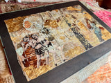 Angled view of the textured layers and gold leaf in Lillian Shad's mixed media art.