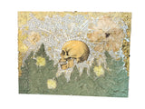Lillian Shad's 'Life Among Death' mixed media art with a skull, gold leaf, and pressed flowers.