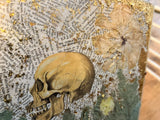 Skull illustration and pressed flower layered with gold leaf in 