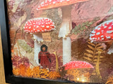 Detailed view of a child figure collaged among red toadstools and dried flora.