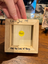 Lillian Shad's handwritten signature, date, and title on the back of the wooden art piece.