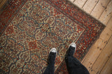 Overhead view of an antique Farahan Sarouk's allover field with shadow medallion and turtle motifs.