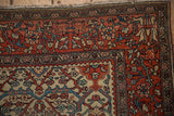 Corner detail showing the palmette border with meandering vines on an antique Farahan Sarouk.