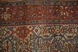 Detail of the palmette cross-section border with meandering vines on an antique Farahan Sarouk rug.