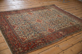 Antique Persian Farahan Sarouk rug viewed from an angle, showcasing its intricate allover Samovar design.