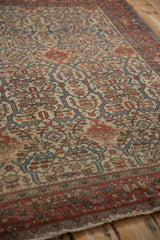 Detailed texture of an antique Farahan Sarouk, showing the low pile, knot heads, and intricate palmette border.