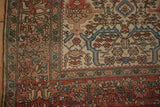 Detailed view of the Farahan Sarouk corner, showing the knot heads and intricate vine border.