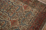 Angled view of the antique rug's field with shadow turtle motifs and its palmette border.
