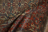 Antique Persian rug folded to contrast the ruby red palmette border with the ivory field.