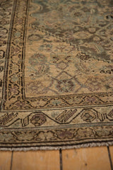 Worn pile and exposed knot heads showing the character of a vintage Persian runner.