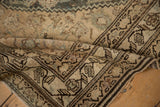 Distressed, hand-knotted texture and detailed charcoal border on a folded corner of the Hamadan runner.