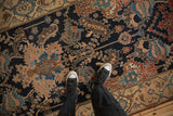 Finely detailed dragon stylized leaves and checkered patterns on an antique Malayer runner's navy field.