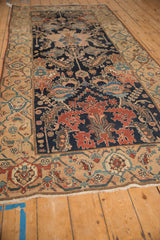 Angled perspective of an antique Malayer runner highlighting its detailed navy field and wide sand border.