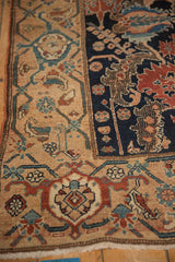 Fine, checkered-like detailing on an antique Malayer rug's navy field and stylized beige border.