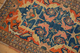 Antique Senneh rug with unusual scrolled leaf and mahi-mahi motifs in indigo, tangerine, blush.