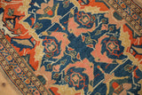 Detail of antique Senneh rug: scrolled gul farang and mahi-mahi motifs in indigo, tangerine, and blush.