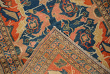 Antique Senneh rug folded corner with rust border, indigo field, and multi-column selvage.
