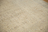 Close-up of a distressed Vintage Kaisary carpet, showing muted ivory, blue, and brown scrolling florals.