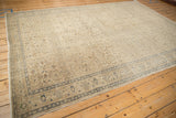 Distressed vintage Kaisary carpet detail, showing faded blue border and allover scrolling vines.