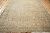 Distressed vintage Kaisary rug with allover scrolling floral pattern in faded ivory, blue, and brown.