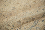 Faded ivory and dusty blue floral motifs on a distressed vintage Kaisary pile.
