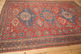 Meandering vine and classic wave motifs on the border of a handwoven antique Caucasian Soumac.