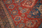 Intricate floral roundels and a geometric vine border on an antique hand-woven Caucasian Soumac carpet.