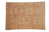 Vintage distressed Oushak with double columns of geometric floral guls in faded mauve and silver.