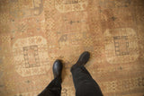 Faded mauve and silver geometric patterns on a distressed Oushak showing even wear to the knots.