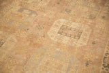Worn, low-pile texture of a vintage Oushak showing faded geometric motifs in mauve and silver.